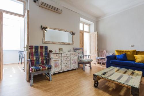 a living room with a blue couch and a table at Sweet Home at Rustaveli Avenue in Tbilisi City