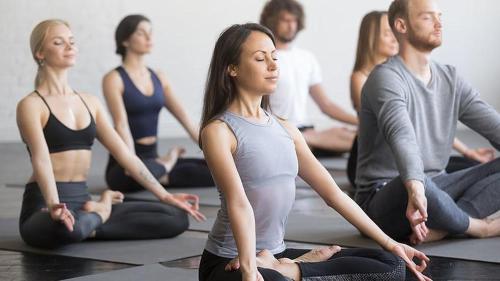 a group of people sitting in a yoga class at Aktivhotel Waldhof in Oetz