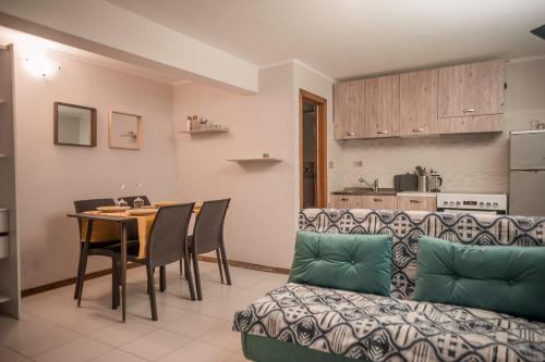 a living room with a table and a couch at Holiday Gufetto in Pietra Ligure