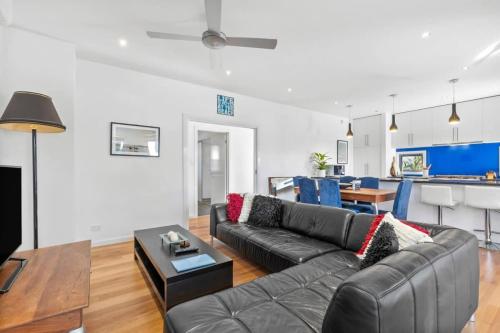 a living room with a couch and a table at Sunset Days Family Holiday House 200m to Shops in Ocean Grove