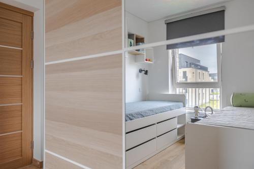 a small bedroom with a bed and a closet at Fantasy House, cozzy apartmens, free parking, long stays welcome in Vilnius