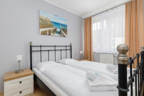 a bedroom with a large bed and a window at Apartment Nautilus Swinoujscie Promenade by Renters in Świnoujście