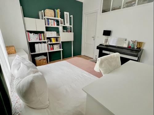 Apartment near to Paris (7 minutes) في أسنيير-سور-سين: غرفة نوم بسرير ابيض ومكتب