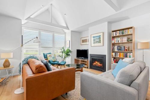 a living room with two couches and a fireplace at Coastal Class and Sophistication 500m to Beach in Ocean Grove