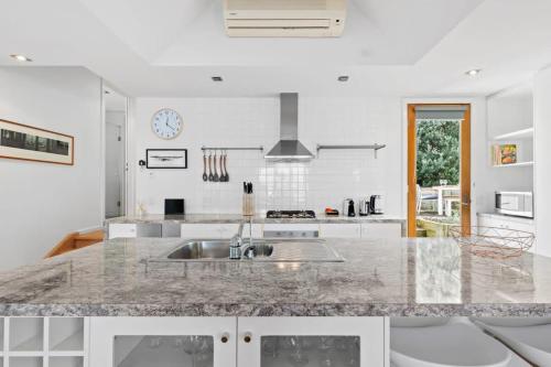 a kitchen with a sink and a counter top at Coastal Class and Sophistication 500m to Beach in Ocean Grove