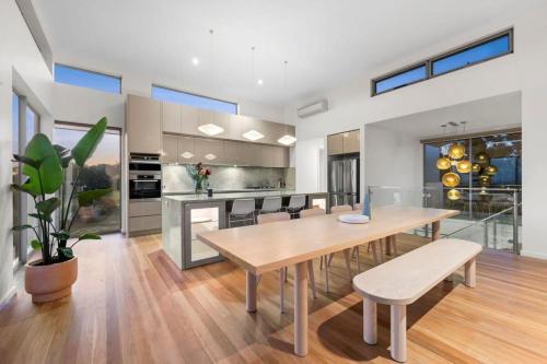 a kitchen with a wooden table and a dining room at Waterline in Bellbrae