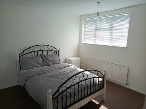 a bedroom with a bed and a window at Remarkable 4-Bed House in Chatham in Chatham