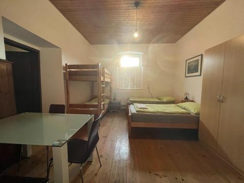 a room with two beds and a desk and a table at 3144 Zur Alten Forstkanzlei in Wald