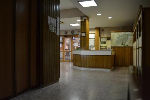 a hallway of a building with a kitchen and a counter at Hotel Rausan in Alfajarín