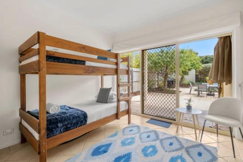 a bedroom with a bunk bed and a balcony at Absolute Beachfront Retreat on The Esplanade in Torquay