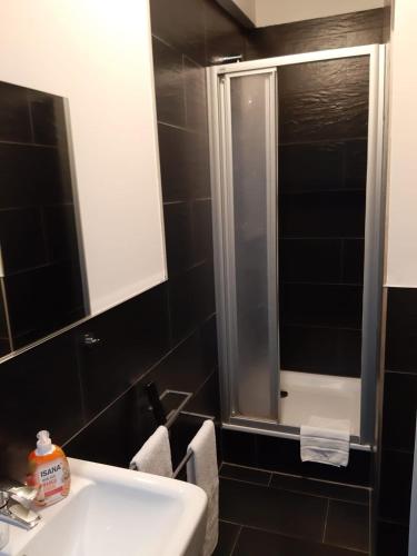 a bathroom with a sink and a glass shower at Ballhaus Berlin Hostel in Berlin