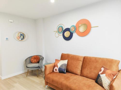 a living room with a couch and a chair at Apartamentos Centro Oviedo Caveda in Oviedo