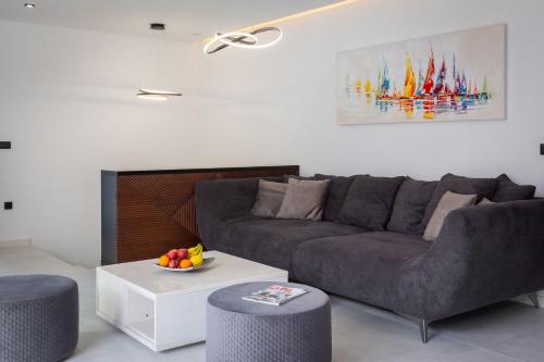 a living room with a couch and a table at Villa royale with shared pool in Hvar