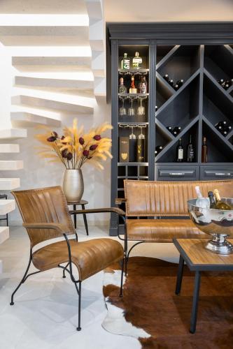 a living room with a bench and a wine cellar at Villa royale with shared pool in Hvar