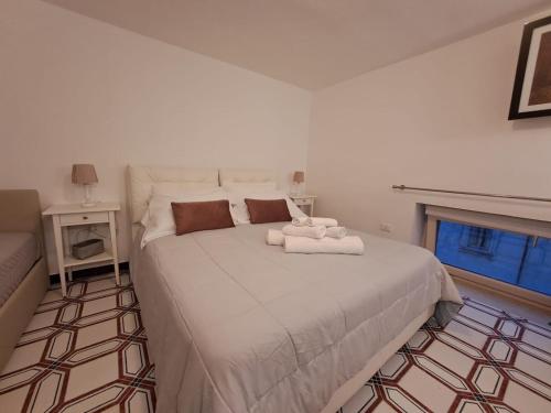 a bedroom with a large white bed with a window at Dimora Vico Storella in Lecce