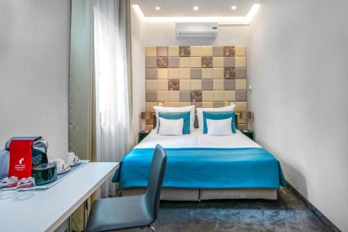 a hotel room with a bed and a chair at Hotel President in Budapest