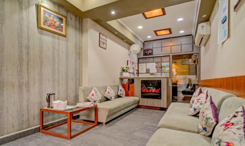a living room with a couch and a table at Treebo Bliss in Jaipur