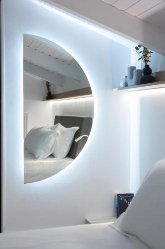 a bedroom with a mirror above a bed at Skyview Suites in Lefkada Town