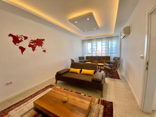 a living room with a couch and a world map on the wall at Old Town Famous Aparts in Antalya