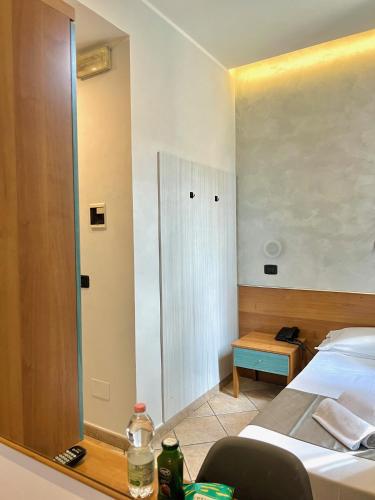a hotel room with a bed and a mirror at Hotel Sara in Milan