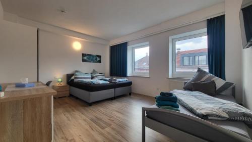 a living room with a bed and a couch at Boardinghouse Heilbronn in Heilbronn