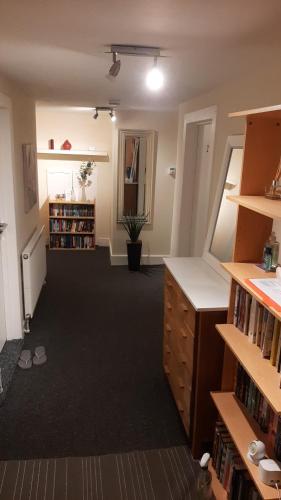 an empty room with bookshelves and a hallway at Beulah Serviced bedrooms in Aberdeen