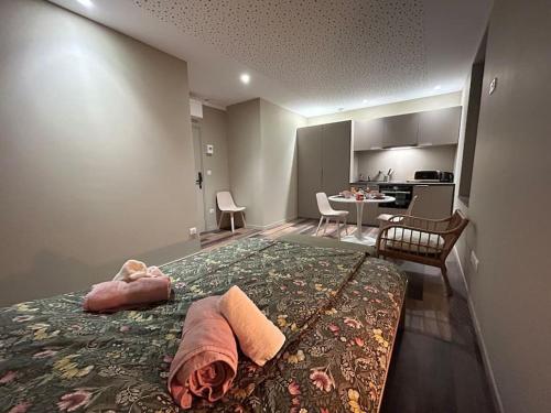 a bedroom with a bed and a kitchen with a table at Antica Stazione in Guebwiller