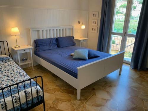 a bed with blue pillows on it in a bedroom at SpazioSanta in Santa Margherita Ligure