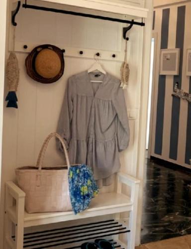a shirt and a basket on a shelf in a room at SpazioSanta in Santa Margherita Ligure