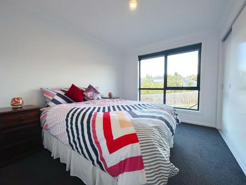 a bedroom with a large bed and a window at Bunny Riveting House at Granton in Grantow