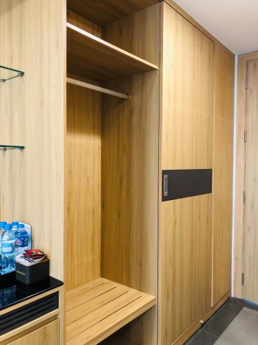 a closet with wooden panels and a door at Hanvet Hotel Do Son in Ðố Sơn