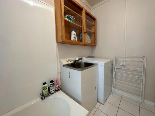 a small bathroom with a sink and a shower at Econo Lodge near Hobart City and Salamanca Market in Hobart