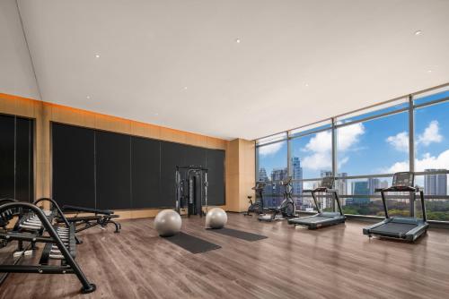 a gym with cardio equipment in a building with a view at Holiday Inn Express Shenzhen Futian Center, an IHG Hotel in Shenzhen