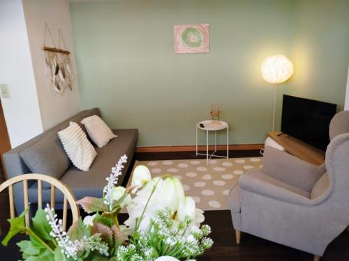 a living room with a couch and two chairs at Révélation Liège in Liège