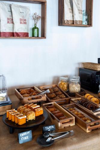 a table topped with trays of different types of food at Hostal Boutique Es Menut in Tossa de Mar