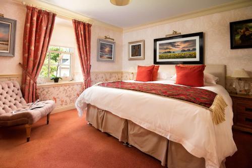 a bedroom with a large bed and a window at Dryburgh Farmhouse in Saint Boswells