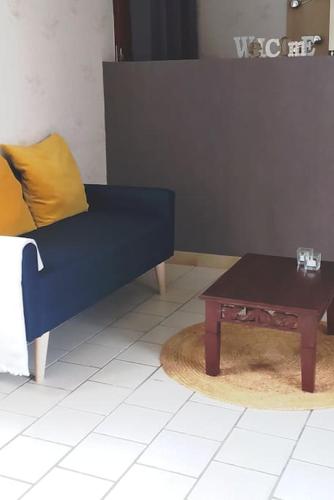 un sofá azul y una mesa de centro en una habitación en Chambre lit double, Salon, Terrasse et jardin, en Couze-et-Saint-Front