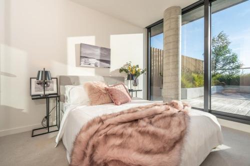 a bedroom with a bed and a large window at Magnificent Retreat facing Albert Park Lake & CBD in Melbourne