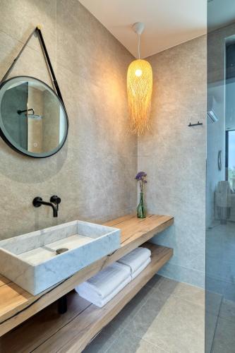 a bathroom with a sink and a mirror at 'S CAVE VILLAS SEASIDE KARYSTOS in Karistos