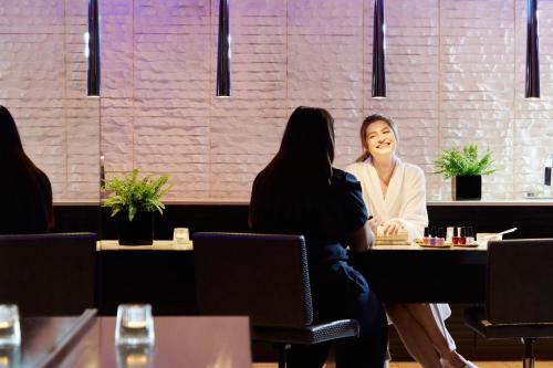 two women sitting at a table in a restaurant at Sheraton Athlone Hotel in Athlone