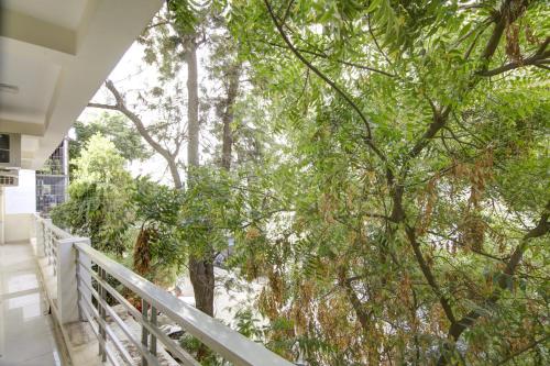 a view from the balcony of a house with trees at Limewood Stay - Executive Huda City Center in Gurgaon