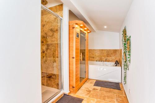 a bathroom with a shower and a tub at La Casa Elisa Family town house in Caen