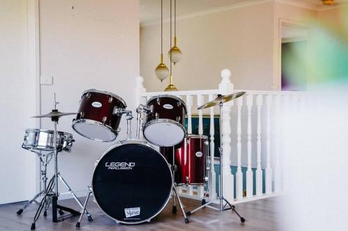 a drum set in a room with a staircase at Prized Home Away from Home in Enviable Location in Narre Warren South
