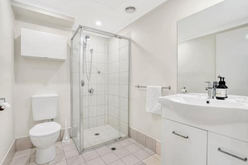 a bathroom with a shower and a toilet and a sink at Gem in heart of Melbourne CBD in Melbourne