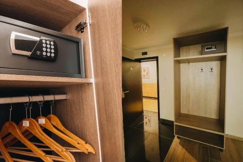 a room with a door with a microwave at Хижа Марциганица in Asenovgrad