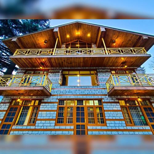 a building with balconies on top of it at Oski Inn in Manāli