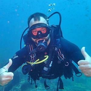 a man is giving a thumbs up in the water at De Silva Palm Resort in Kalpitiya