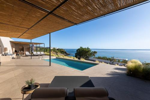 an outdoor patio with a view of the ocean at 'S CAVE VILLAS SEASIDE KARYSTOS in Karistos