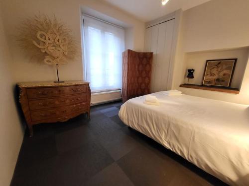 En eller flere senge i et værelse på Appartement avec terrasse