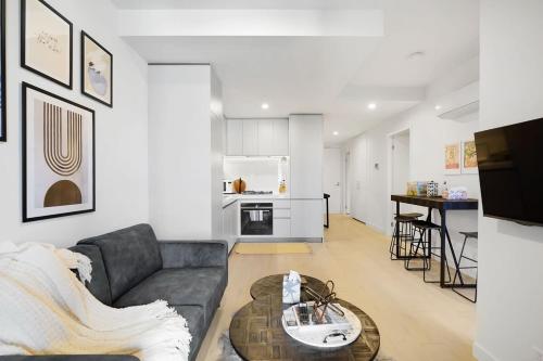 a living room with a couch and a table at Cozy Nest in Prime Hawthorn w parking & pool in Melbourne